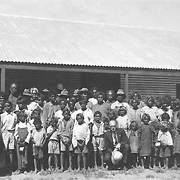 Staff and residents of the Little Flower Mission School, standing outside the school [title altered from original]